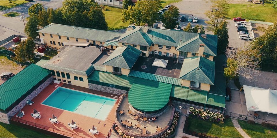 The Thousand Islands Club building and outdoor pool viewed from above.