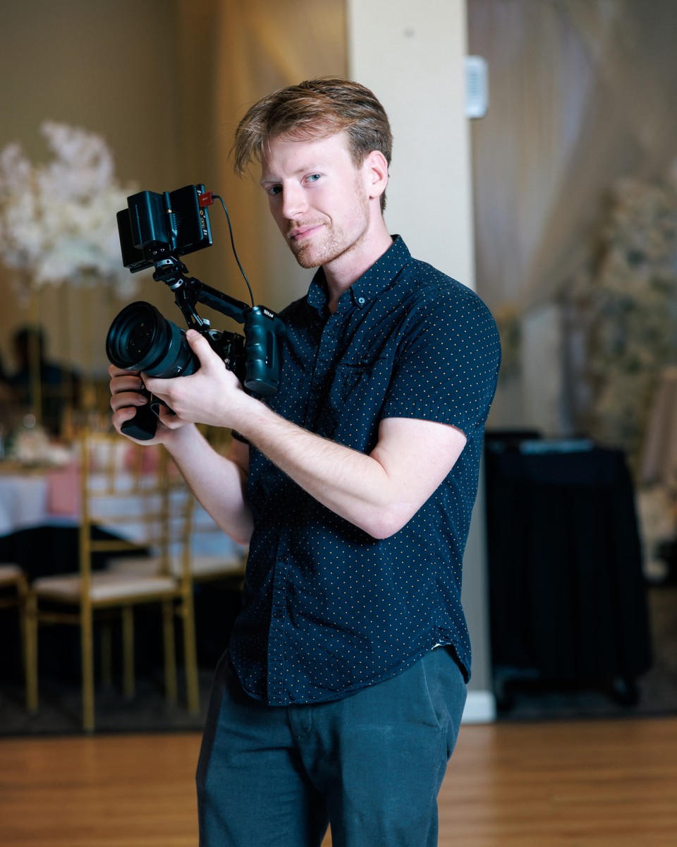 Tyler Strader holding a cinema camera.